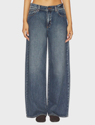 A model wearing the 95 Super Baggy jeans in a casual setting, showcasing their oversized fit and stylish design.