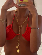 Person wearing a red bikini top with a gold chain and coins, holding a phone with a colorful case Cyprus Necklace Gold Susmies