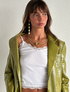 Woman wearing a green jacket over a white lace top against a plain  Tears On My Own Earrings by Susmiesbackground