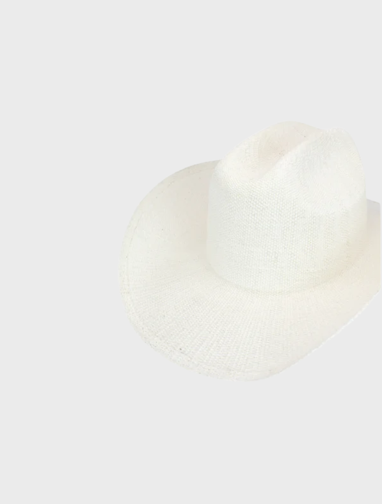 White Addison Cowboy hat positioned on a wooden background, emphasizing its iconic western look and elegant design.