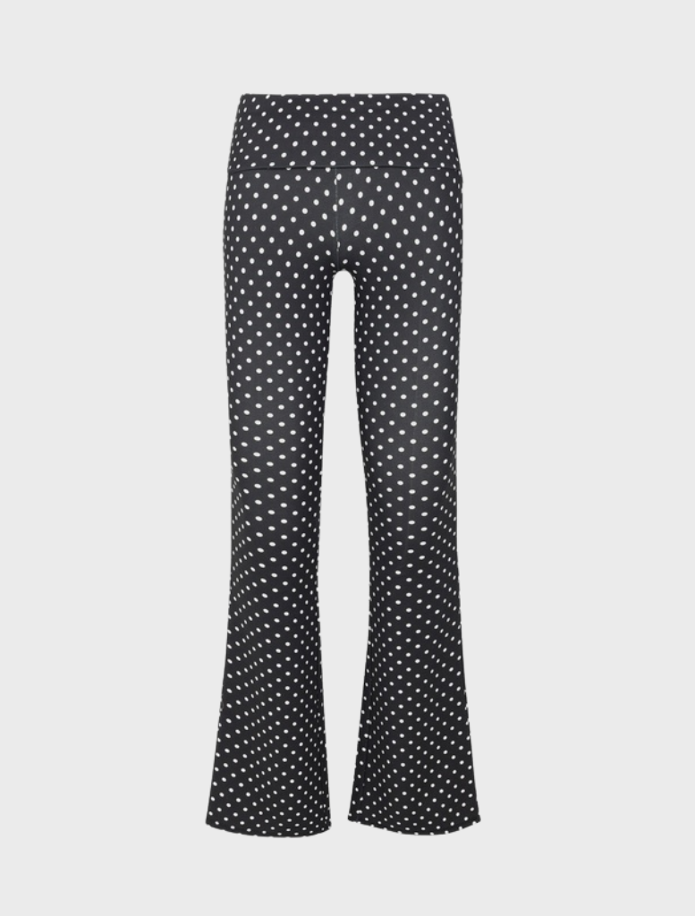 Elegant black pants adorned with small white dots, perfect for versatile styling in various settings.