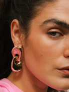 A pair of gold tone earrings with a sleek circular design, perfect for adding a touch of elegance to any outfit.