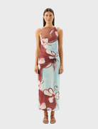 Avalon Dress in Marisol Bloom features a vibrant floral pattern on a flowing fabric, perfect for spring or summer occasions.