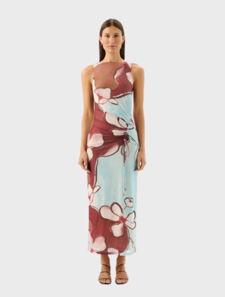 Avalon Dress in Marisol Bloom features a vibrant floral pattern on a flowing fabric, perfect for spring or summer occasions.