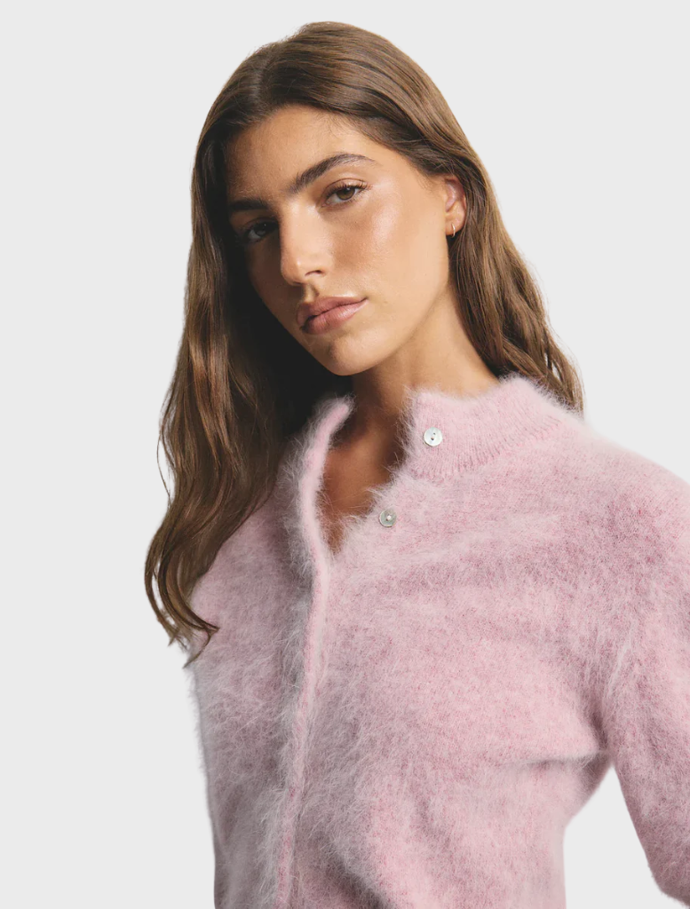 Soft pink Bella Cashmere Cardigan named Petal Cloud, showcasing a luxurious texture and refined style.