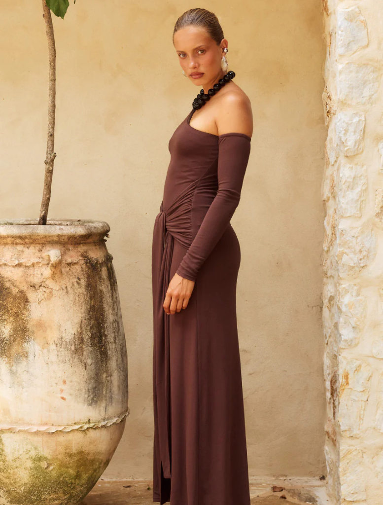 Sophisticated chocolate one-shoulder maxi dress, featuring a long, elegant design suitable for formal occasions and gatherings.