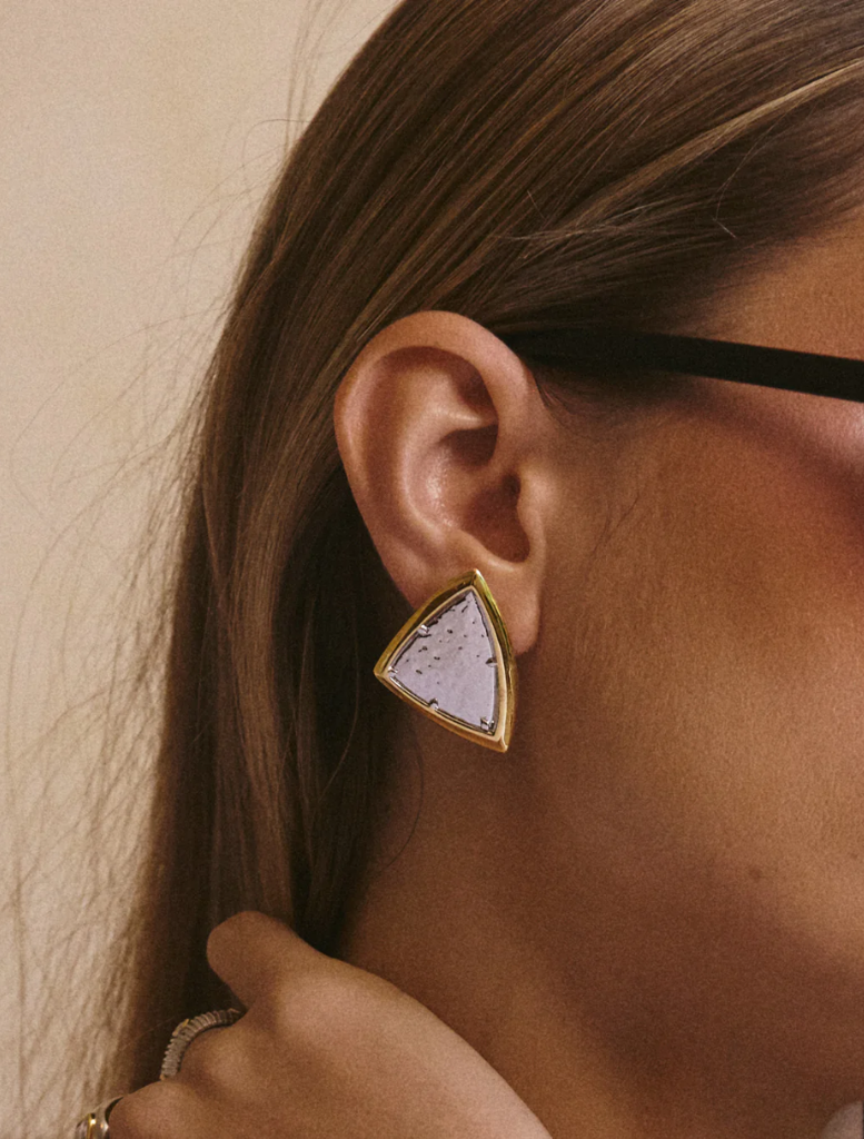 Elegant two-tone triangle stud earrings in gold and silver, known as Bianco Nero Studs - Gold, ideal for stylish accessorizing.