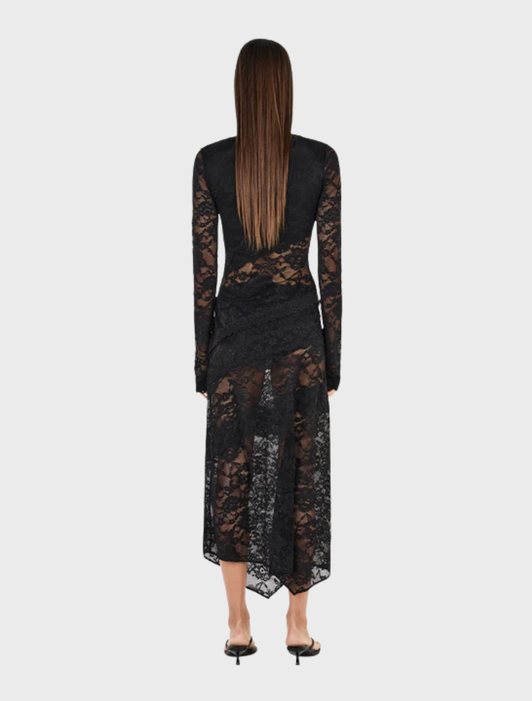 Elegant black Avery top hanging, showcasing a minimalist style ideal for versatile outfit combinations.