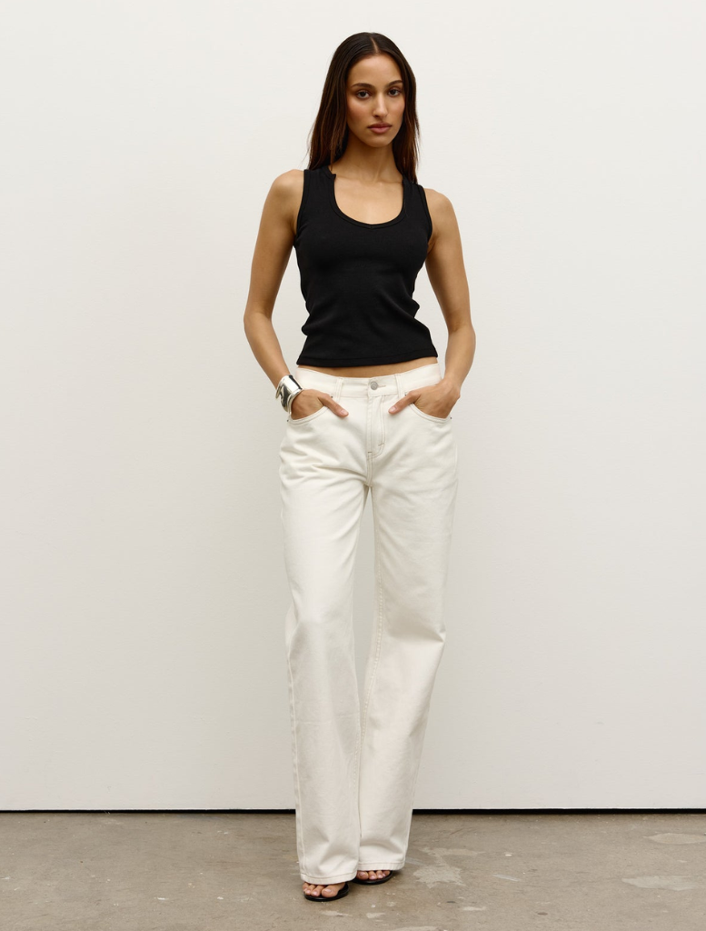 Black Devon tank top laid out, showcasing its modern cut and soft fabric ideal for layering or solo wear.