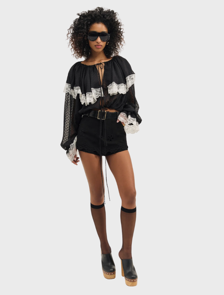 Elegant black June top hanging, showcasing a versatile style ideal for various occasions.