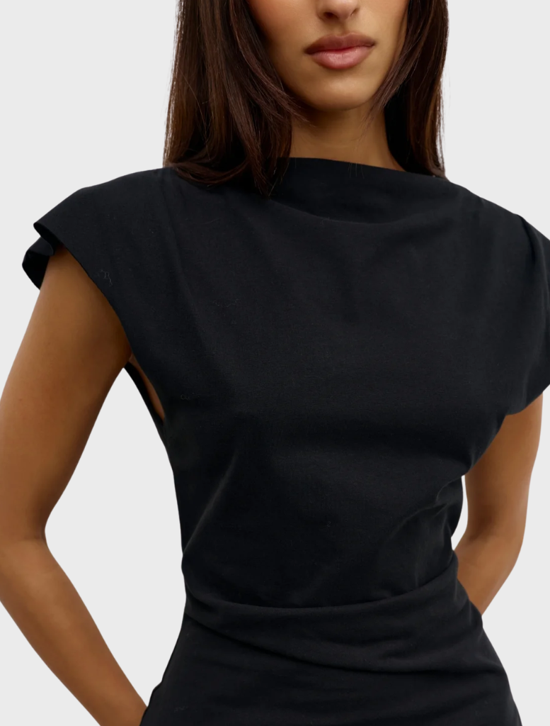 Elegant black Liana top hanging, highlighting its modern style and smooth material.
