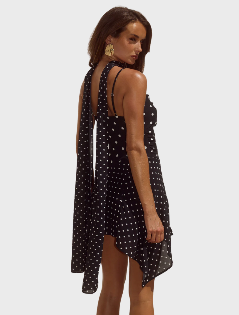 Alora mini dress in black and white polka dots, designed with a scoop neck and a flattering, fitted cut.