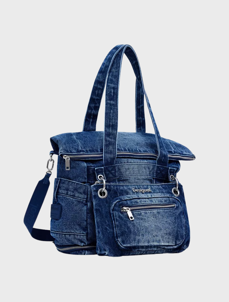 Compact blue denim backpack with a zipper closure, ideal for everyday use and stylish on-the-go organization.