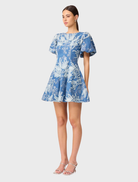 Blue and ivory A-line mini dress showcasing a fitted bodice and flared skirt, perfect for warm weather gatherings.