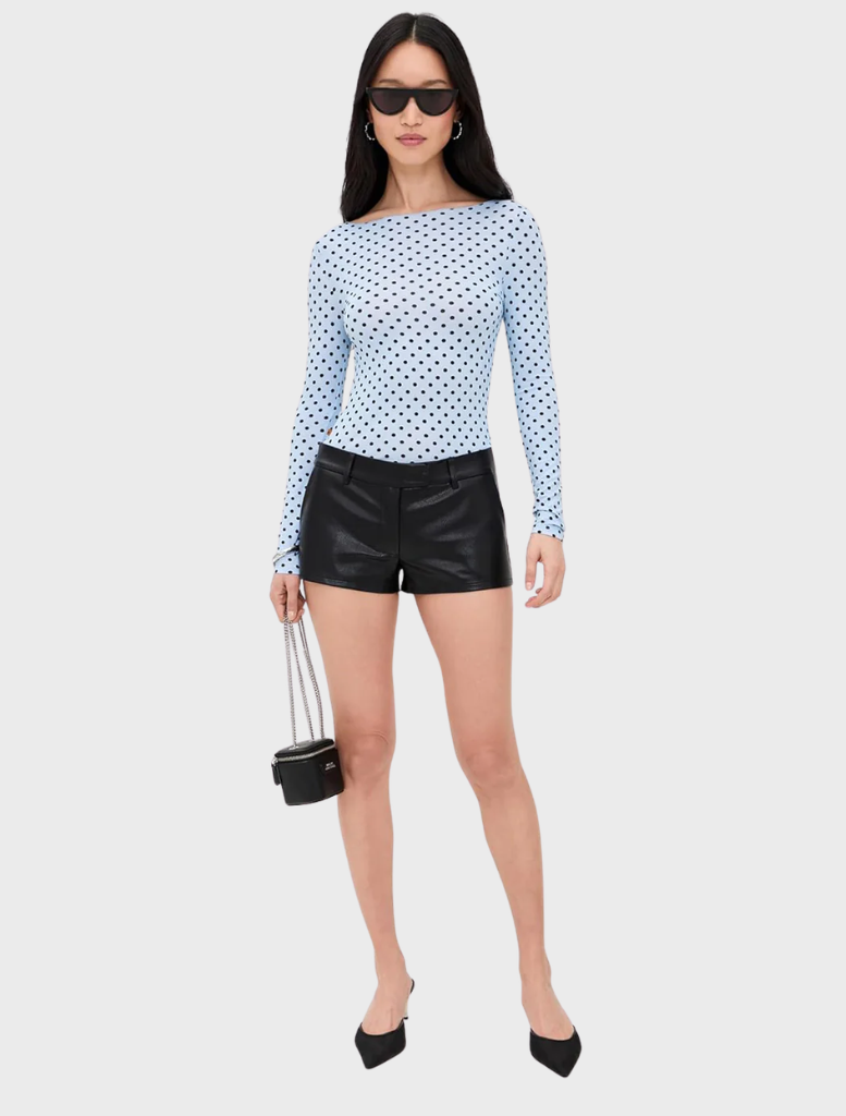 Blue Amelia Top with a pattern of small white dots, perfect for adding a touch of fun to any outfit.