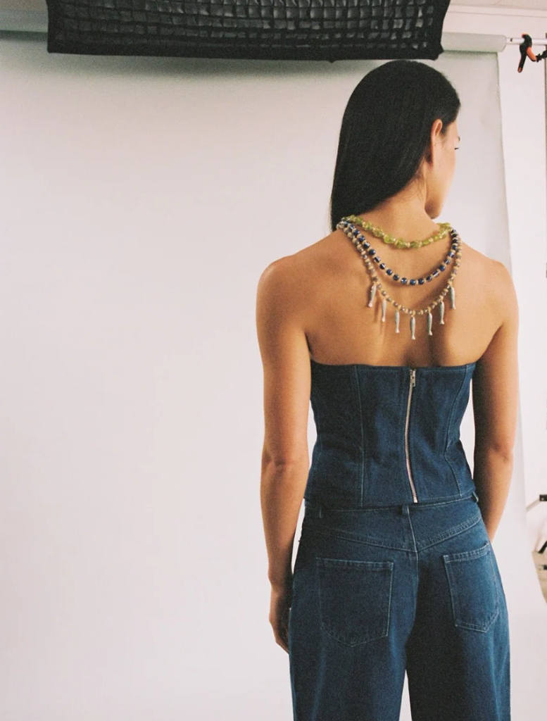 Stylish bluestone denim bustier with a tailored fit, perfect for adding a chic touch to any outfit.