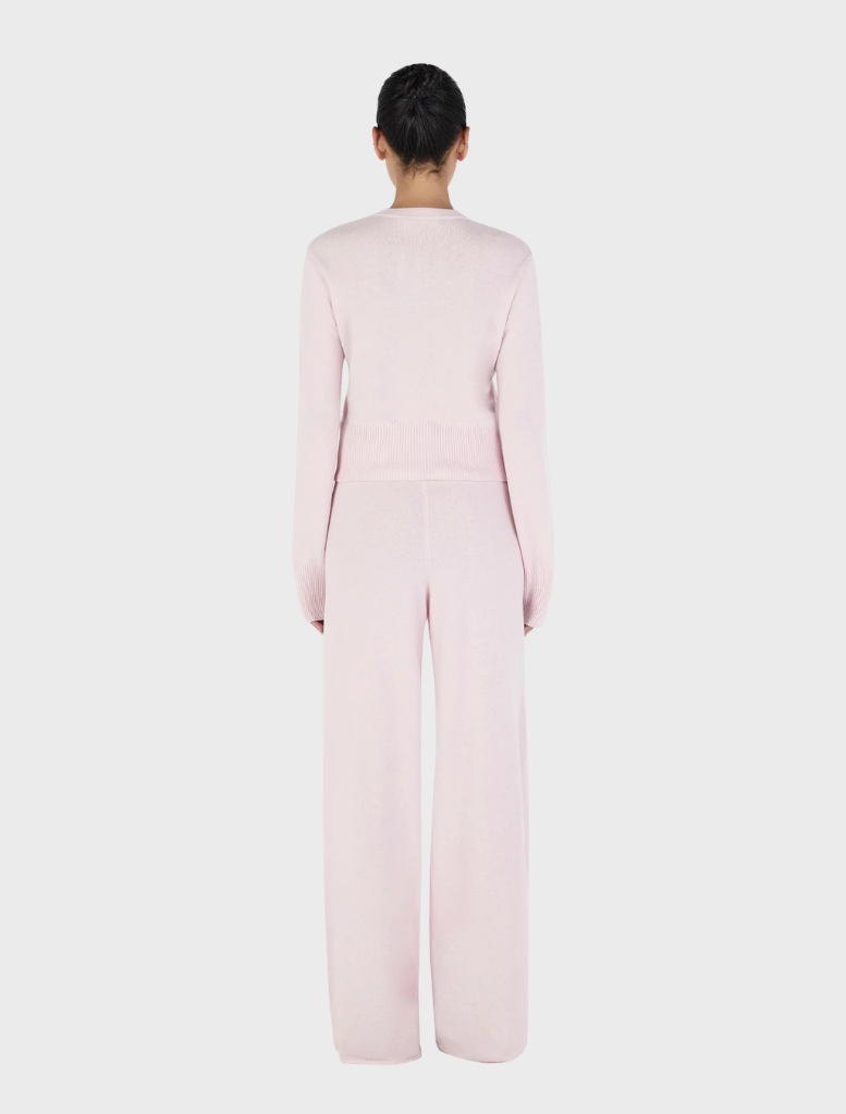 Soft blush Lucielle Cashmere Cardigan draped elegantly, highlighting its luxurious fabric and stylish silhouette.