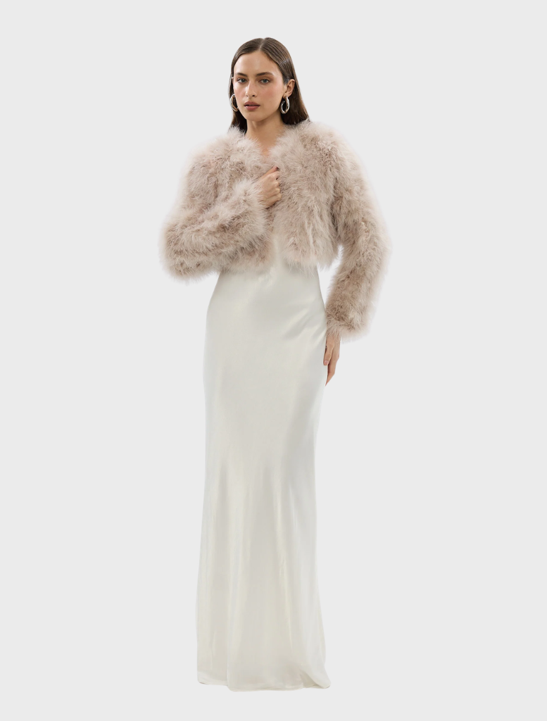A blush-colored Manhattan crop jacket showcased, highlighting its contemporary style and tailored fit.