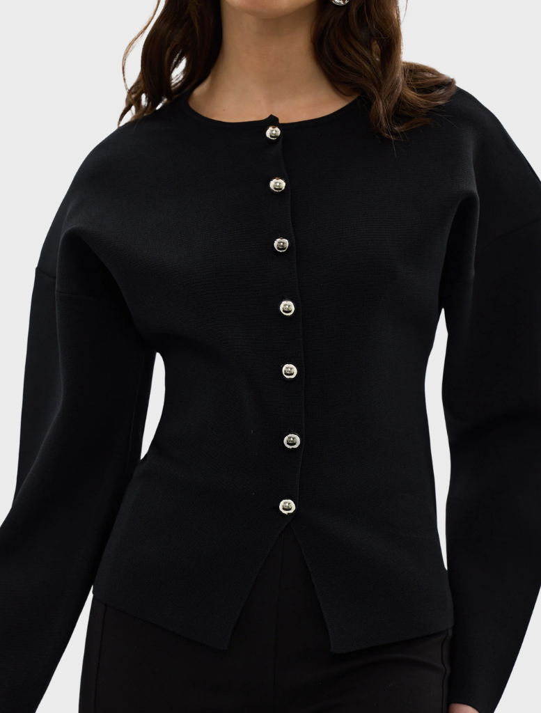 Black Bronte knit cardigan draped on a model, emphasizing its stylish and comfortable appearance.