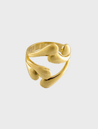 A gold ring adorned with intricate leaf designs showcases a nature-inspired elegance.