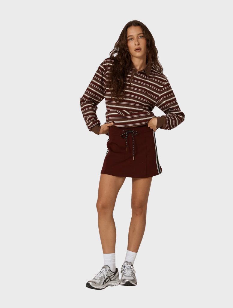 Burgundy Palmer mini skirt shown flat, illustrating its chic design and soft material suitable for various occasions.