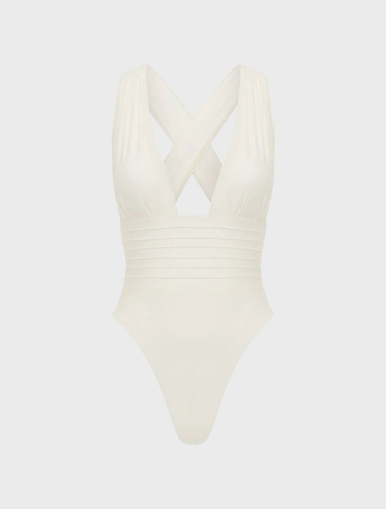 Chic ivory one-piece swimsuit laid flat, highlighting its smooth fabric and minimalist style.
