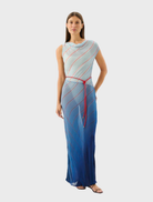 Capri maxi dress featuring a vibrant striped pattern inspired by ocean waves and beach colors.