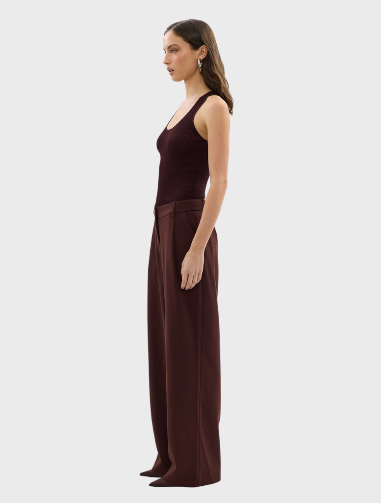 Elegant Bordeaux Carmen pants featured prominently, emphasizing their tailored fit and luxurious fabric.