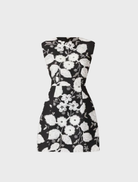 Chic black and white Carol Tulip mini dress showcasing a floral print and a flared design, suitable for various events.