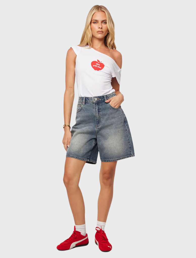 Carrie Short is seen smiling warmly, dressed in a stylish outfit, exuding confidence and a friendly aura.