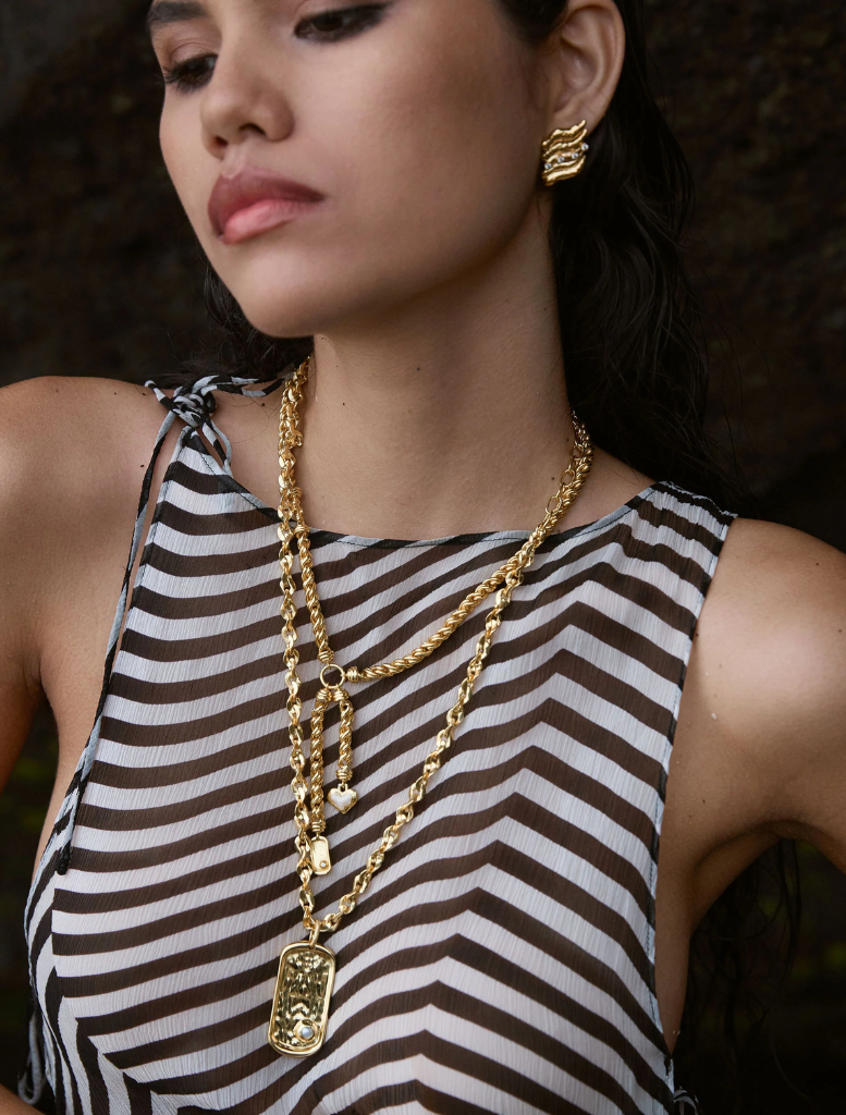 Gold Cassia necklace featuring an elegant design with intricate detailing and a polished finish.