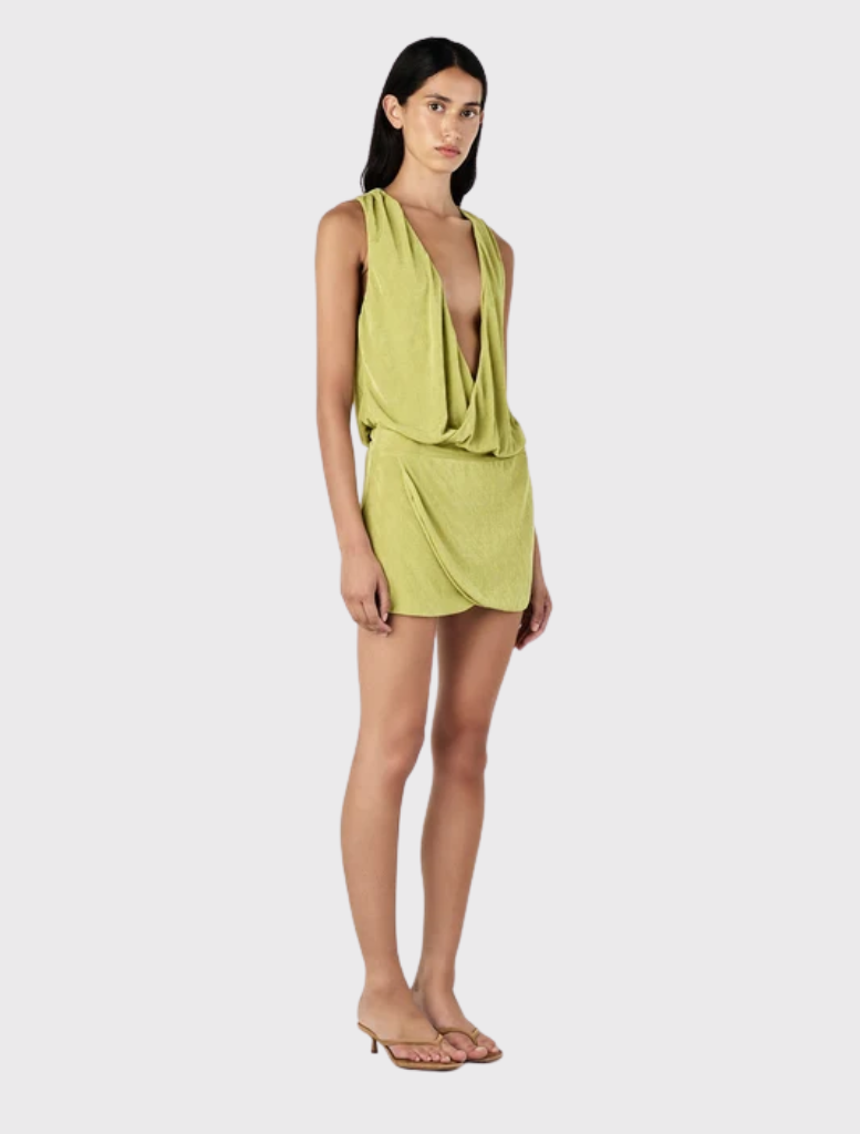 Chelley Mini Dress in Kiwi features a relaxed bodice, fitted mini skirt, deep V neckline, and draped cowl design.