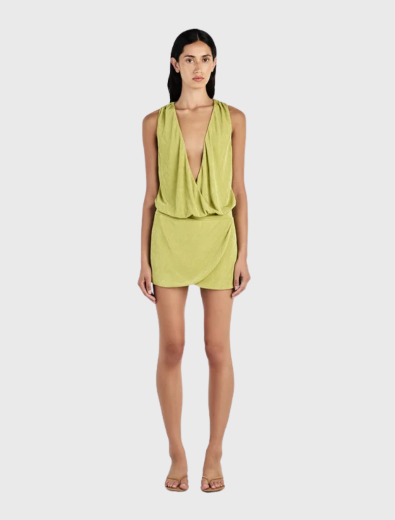 Chelley Mini Dress in Kiwi features a relaxed bodice, fitted mini skirt, deep V neckline, and draped cowl design.
