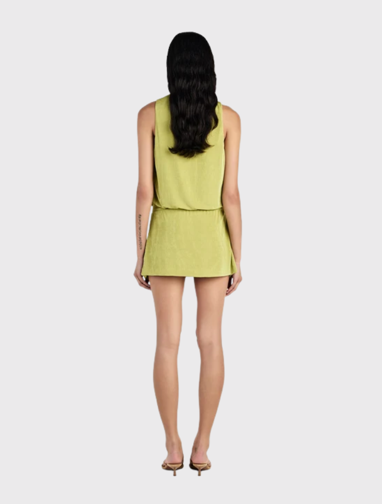 The Chelley Mini Dress showcases a draped bodice, fitted skirt, low cut front, and a stylish front overlay wrap.