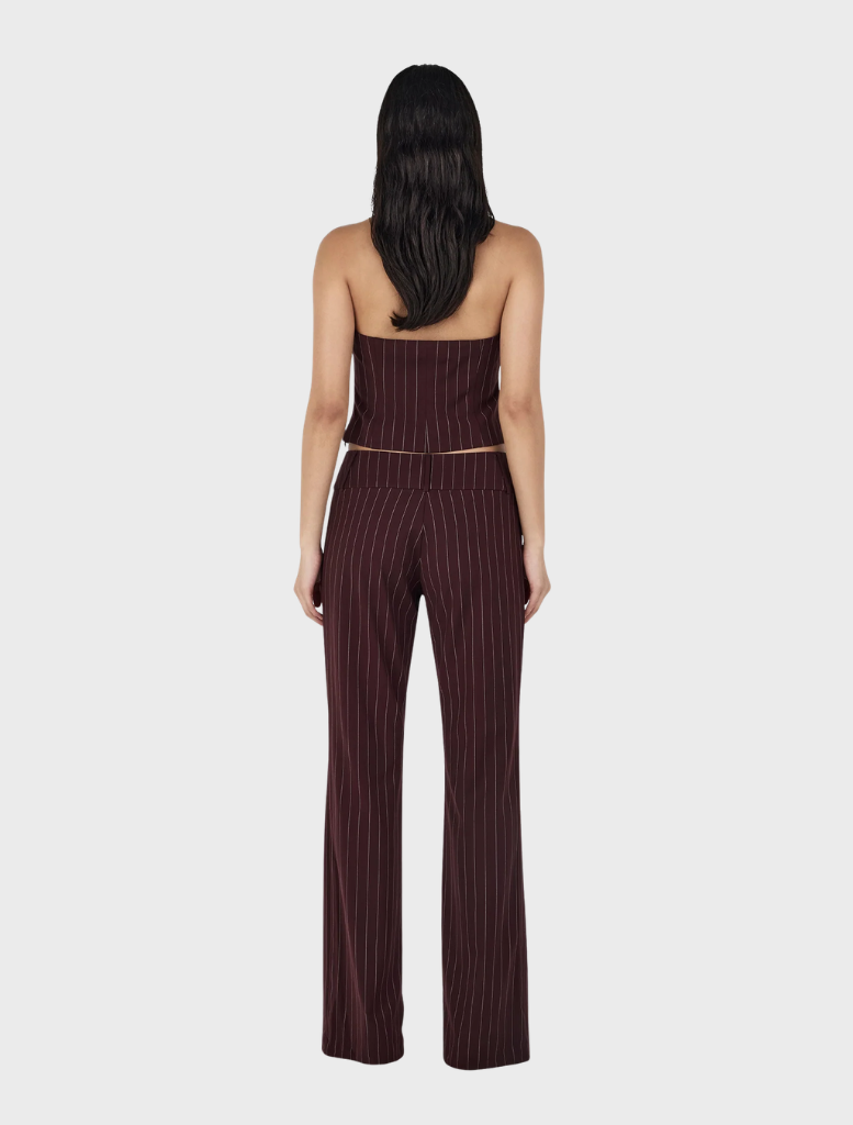 A model displays a burgundy striped top and wide-leg pants, highlighting the Yolanda Suit Pant in Cherry Choc Stripe.