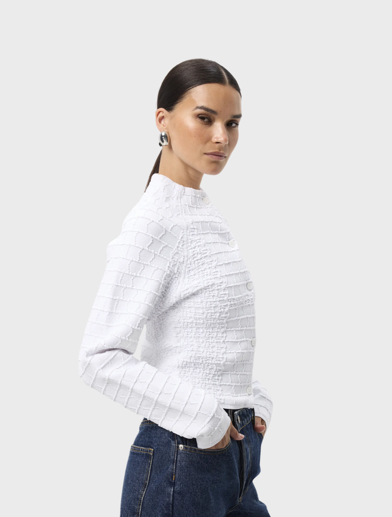 White Carter Cardigan displayed, featuring a timeless design with long sleeves and a soft texture for everyday elegance.