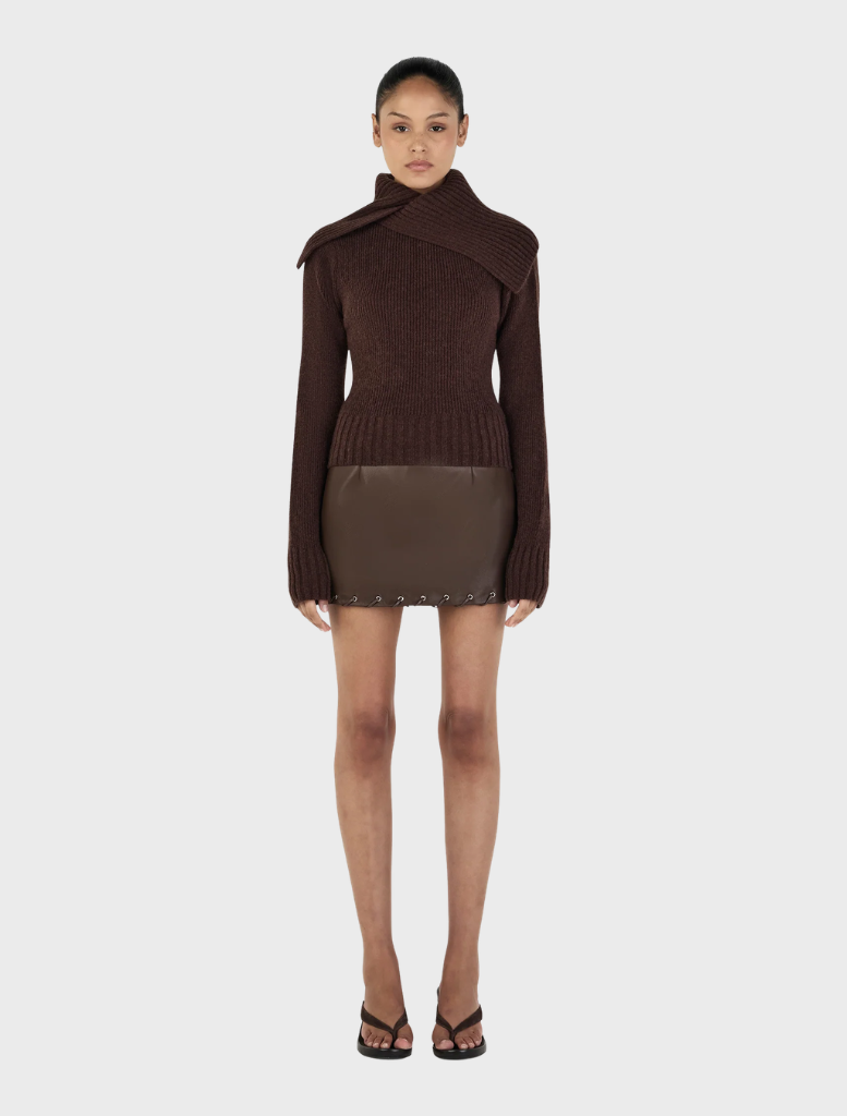 Chocolate-colored Roxanne turtleneck sweater displayed on a neutral background, showcasing its soft fabric and fitted design.