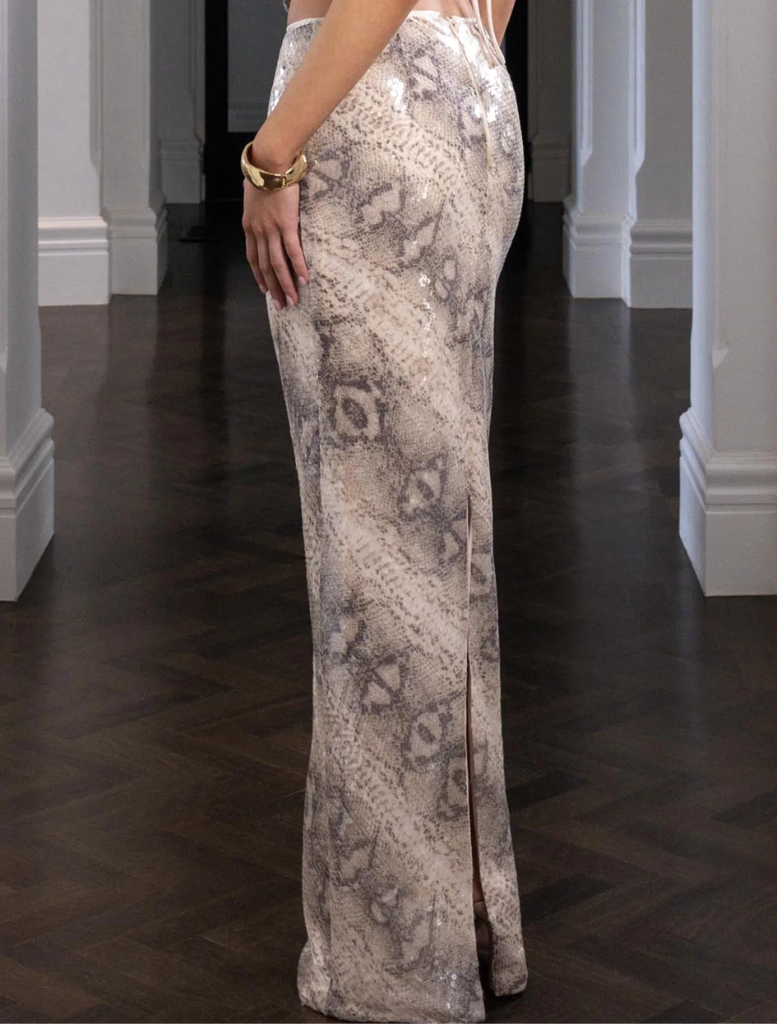 A chic snake-patterned skirt by Christina, ideal for fashion-forward individuals seeking a unique wardrobe piece.