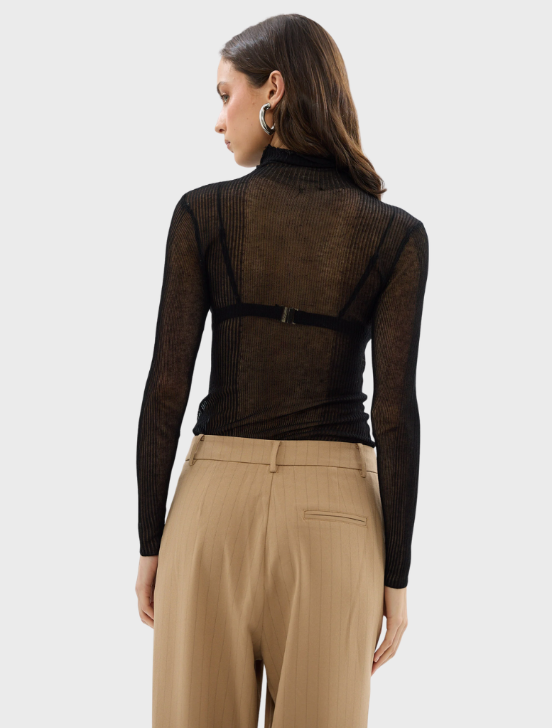 Black Riley top showcased on a hanger, illustrating its chic style and soft texture.