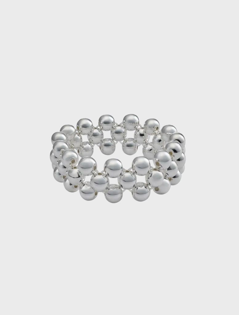 A silver ring adorned with decorative beads, part of the Clover Bracelet collection.