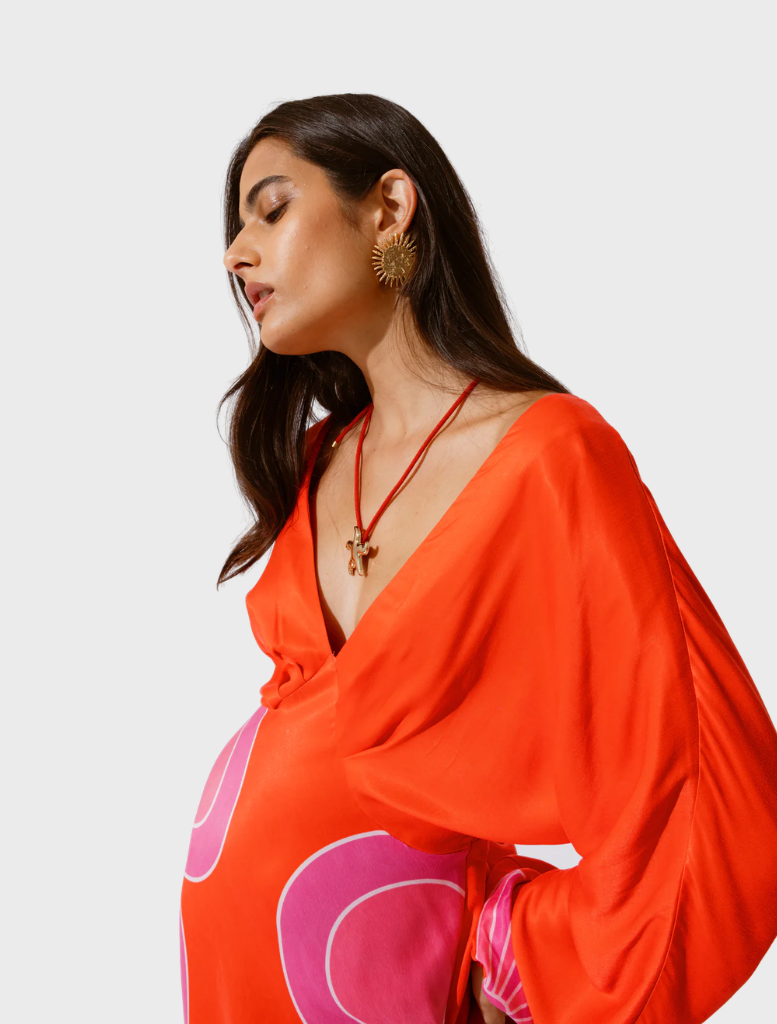 Elegant orange maxi dress featuring long sleeves and a relaxed fit, ideal for various events.