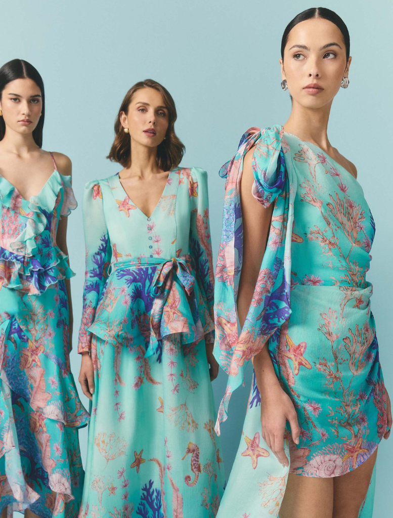 Elegant coral asymmetrical gown with a blue multi-color pattern, showcasing a stylish and modern design.