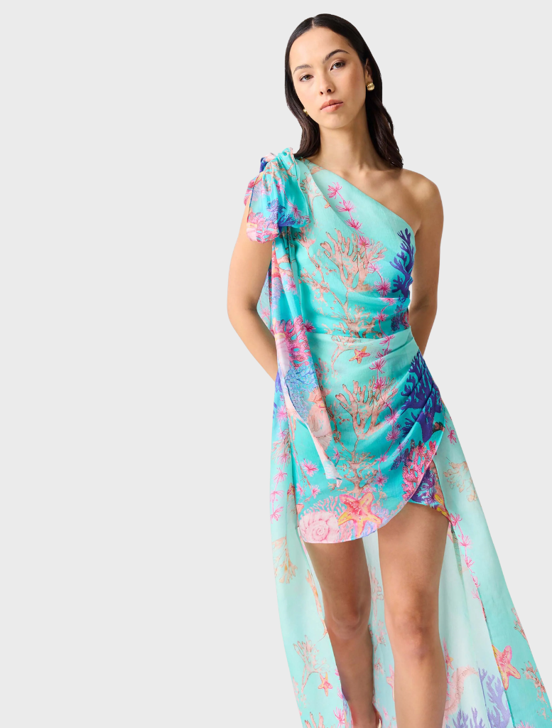 Coral gown with an asymmetrical cut, featuring a blend of blue and multi colors for a vibrant appearance.