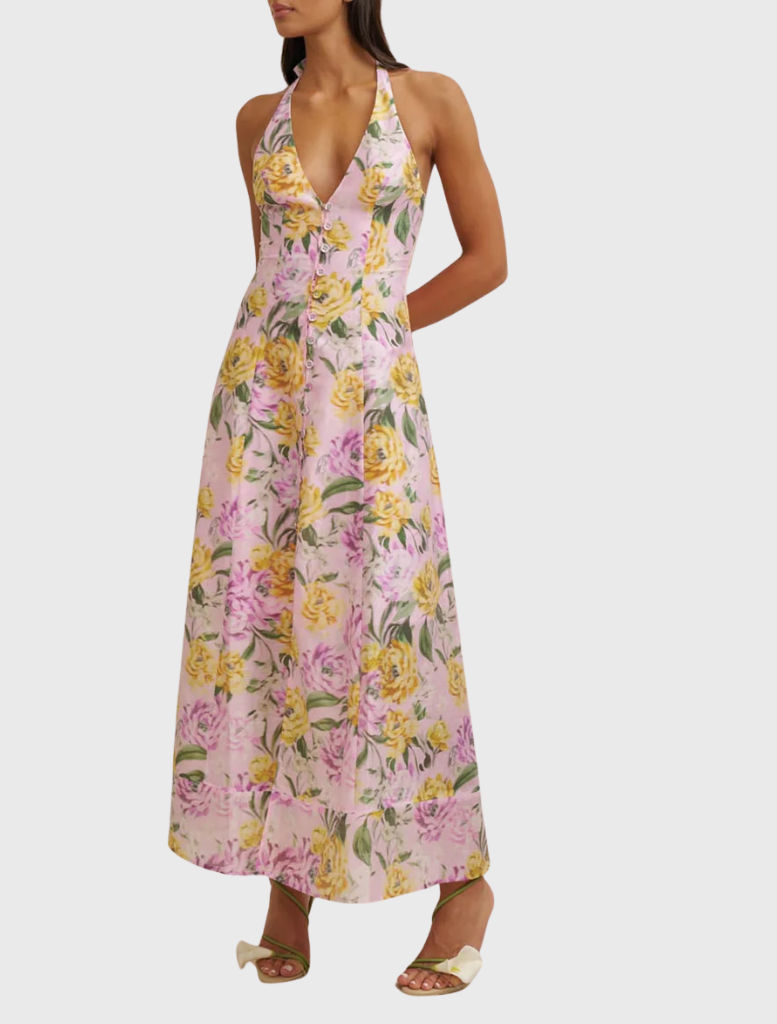 Model in a lilac floral sundress with a halter neckline, showcasing a modern, elegant style for warm weather.