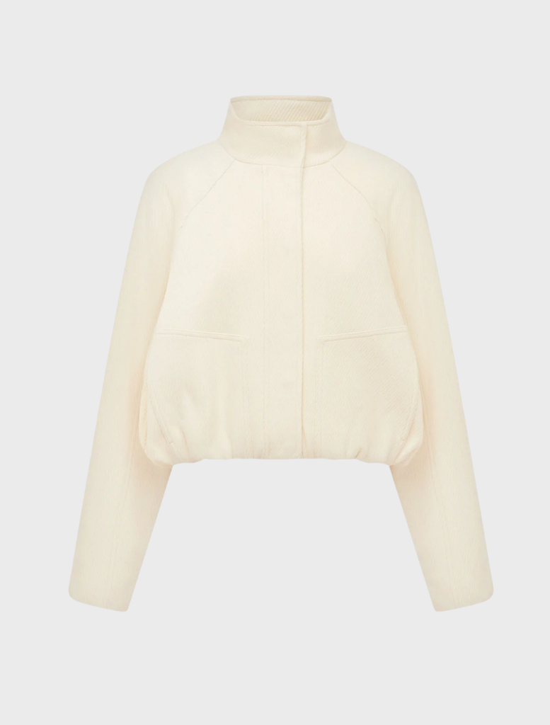 Elegant ivory cropped bomber jacket, showcasing a modern silhouette and ribbed detailing on the sleeves.