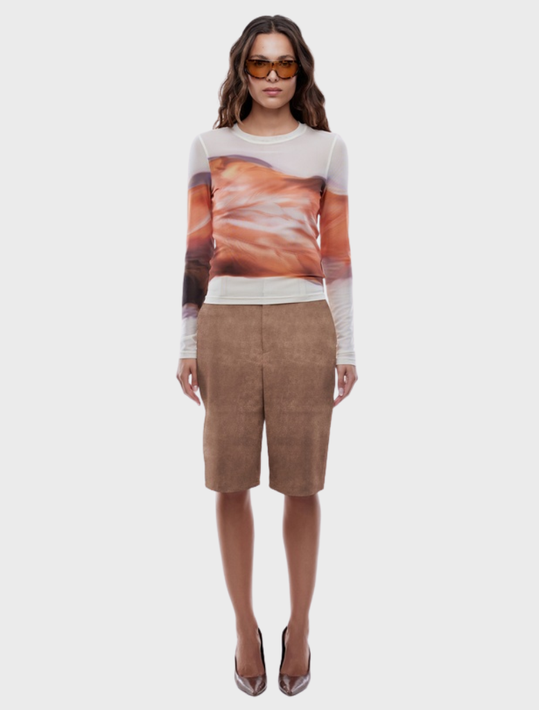 Long sleeve top featuring an autumn leaf print in warm colors, perfect for seasonal wear.