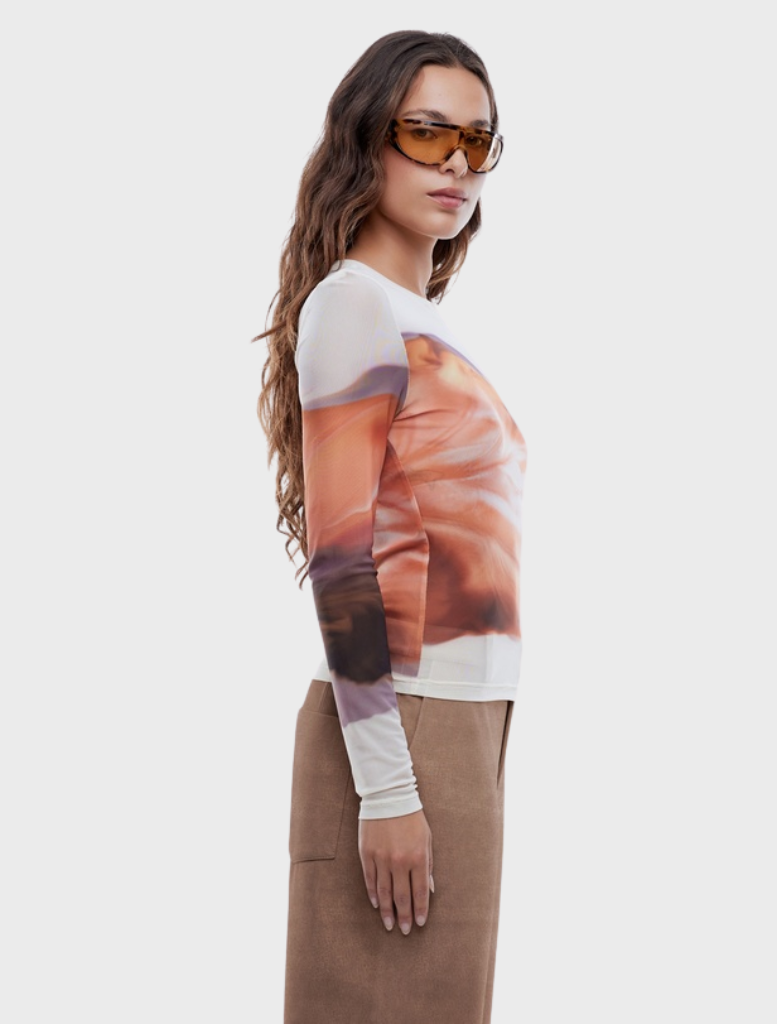 Long sleeve top featuring an autumn leaf print, perfect for seasonal wear and adding a touch of nature-inspired style.