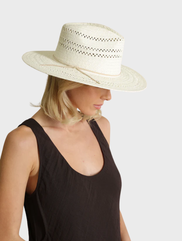 White Debra Fedora hat displayed on a neutral surface, illustrating its refined design and fashionable appeal.