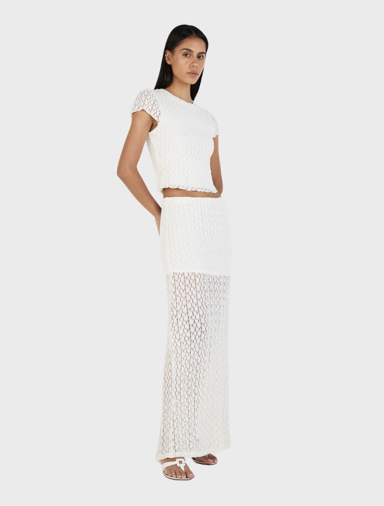 Elegant ivory Delphine skirt shown draped on a hanger, highlighting its soft fabric and sophisticated silhouette.