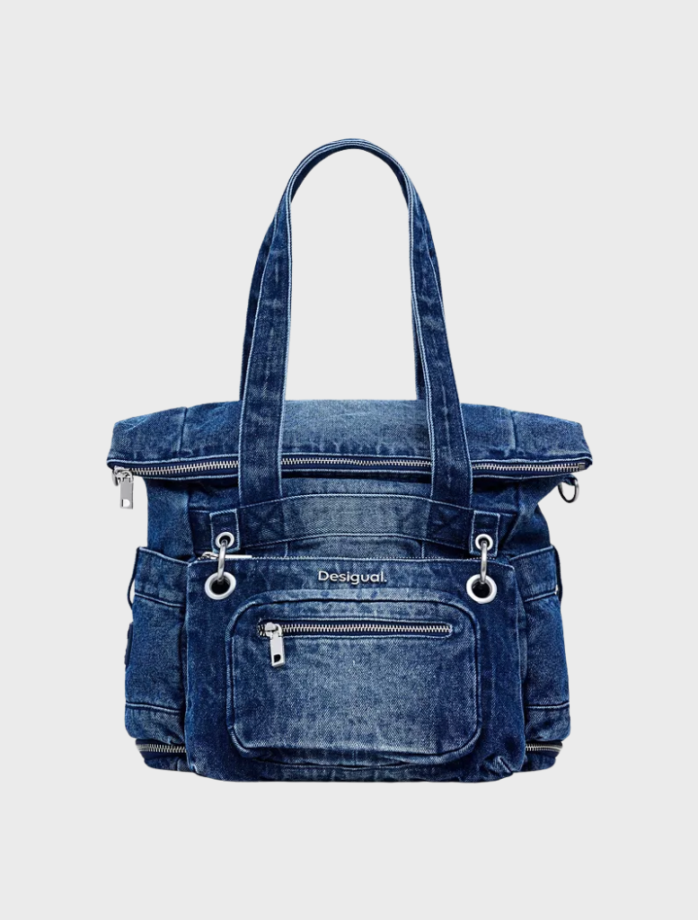 Blue denim mini backpack with a zipper closure, designed for casual use and easy access to belongings.
